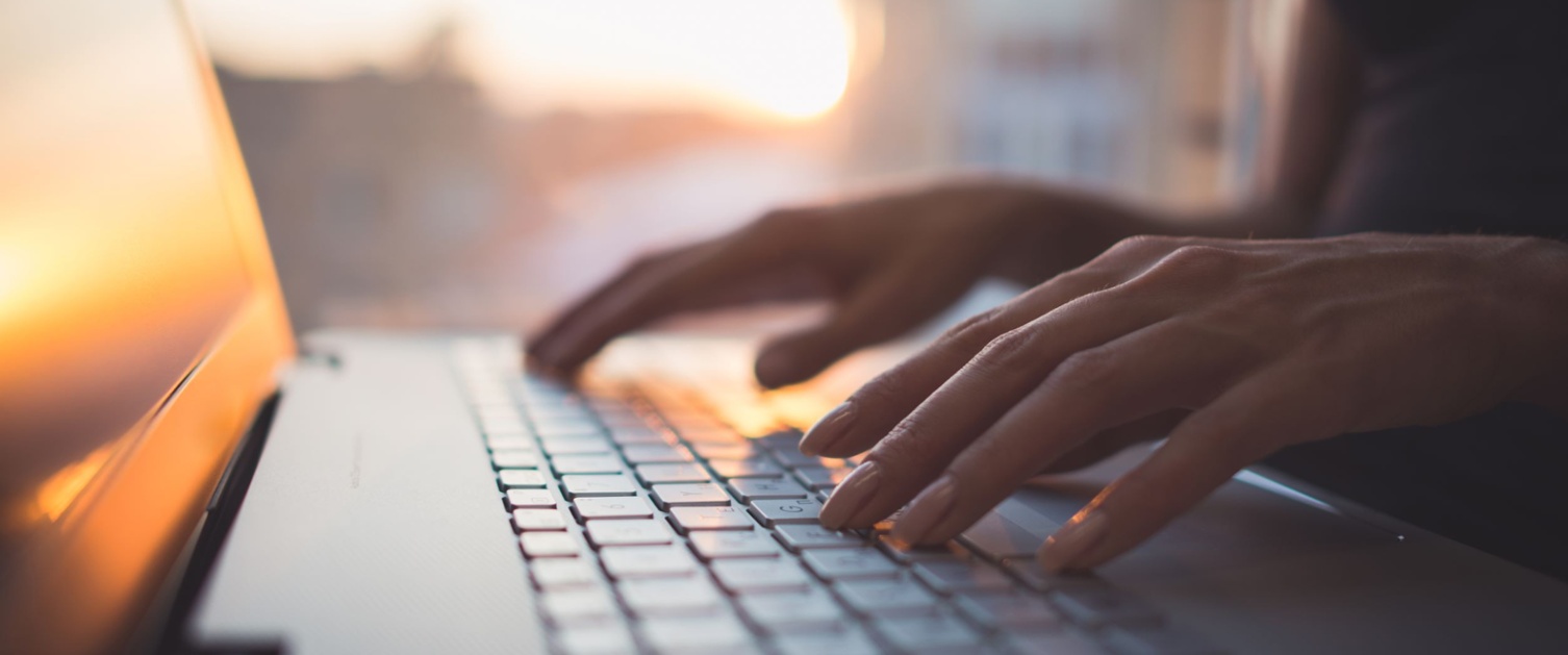 Person typing on a laptop. 