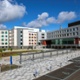 Picture of a hospital with blue skies in the background. 