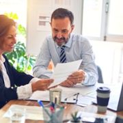 man and woman reading notes on paper