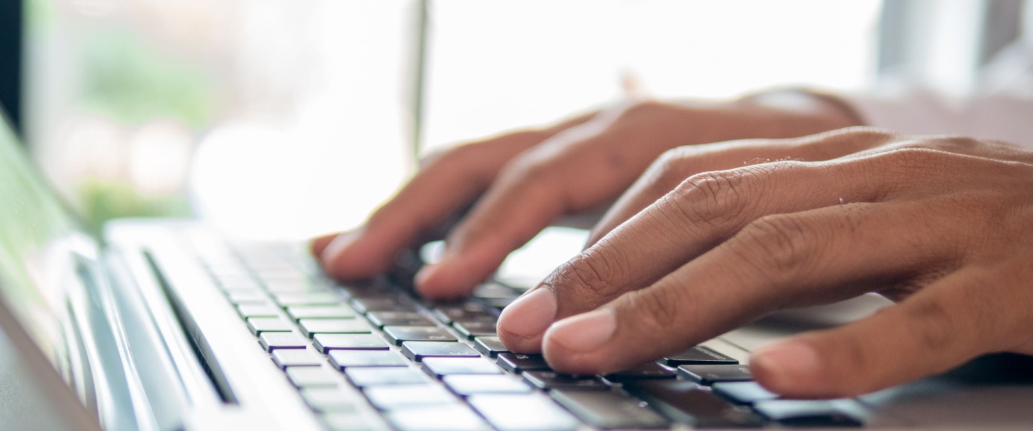 Person typing on a laptop.