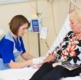 NHS Wales nurse giving treatment to patient