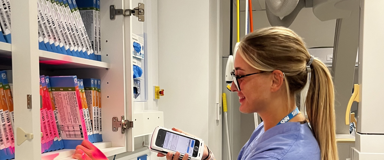 NHS worker scanning items in a cabinet