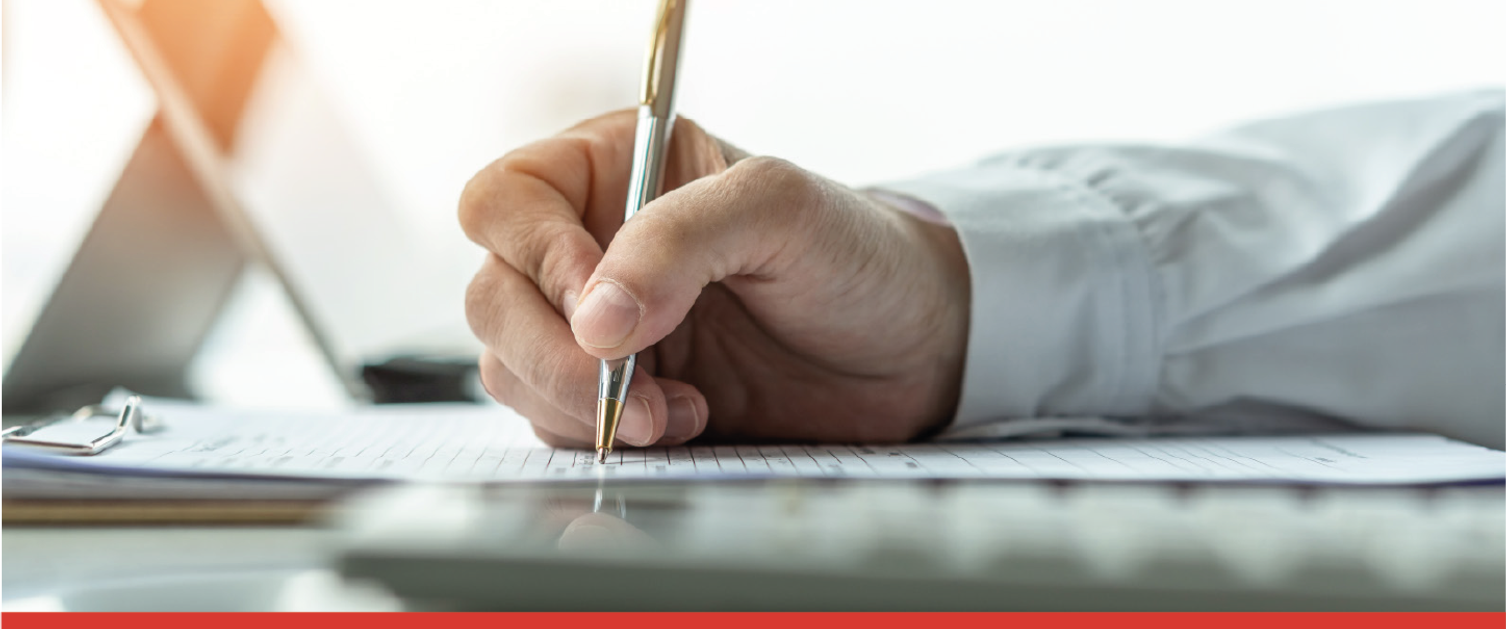 man writing on notepad