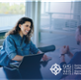 image of a woman and a man sat opposite each other on a desk, having a meeting. 