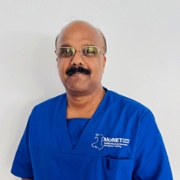 Dr Prem Kumar Pitchaikani in royal blue MoNET scrubs against a white background.