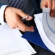 man looking through car documents