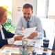 man and woman reading notes on paper