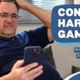 Text Reads: Control harmful gambling. New online support from NHS Wales. Image of male sitting with hand on head looking at mobile phone.