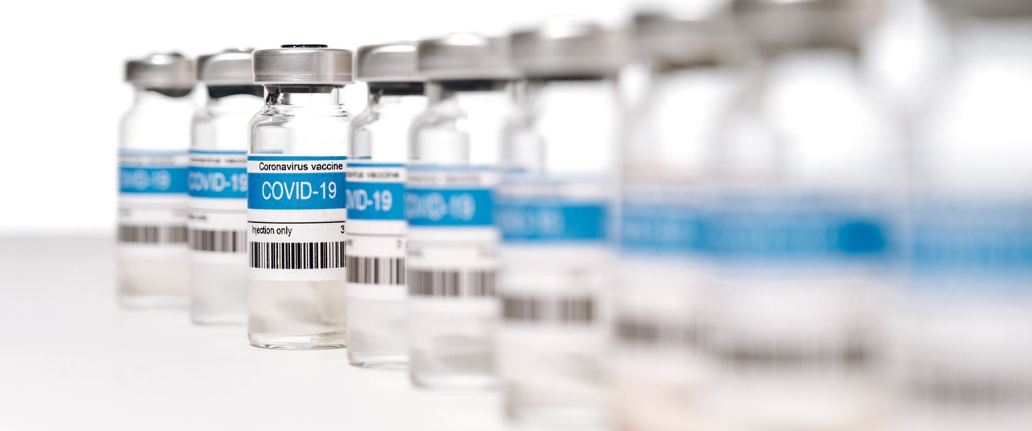 Row of COVID 19 vaccine vials