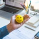 Image of Emoticon ball on male hand on work table.happy life concepts