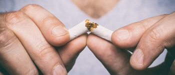 Image of male hand crushing cigarette