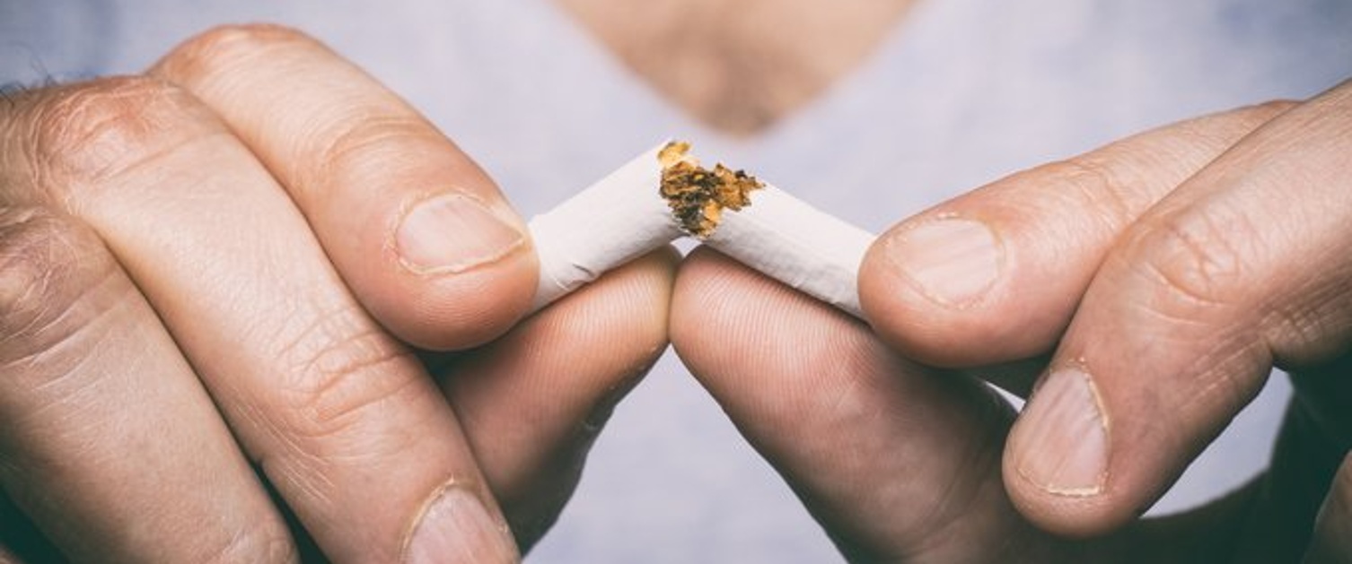 Image of male hand crushing cigarette