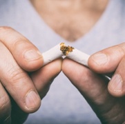 Image of male hand crushing cigarette