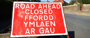 Road Ahead Closed road sign informing traffic of conditions ahead in both English and Welsh language