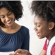Image of Teenager showing exam results to parent in front room