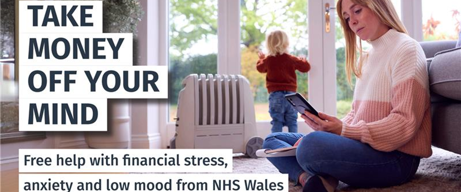 Text Reads: Take Money off your mind. Free help with financial stress, low mood and anxiety from NHS Wales. Image of woman sat on the floor looking at phone.