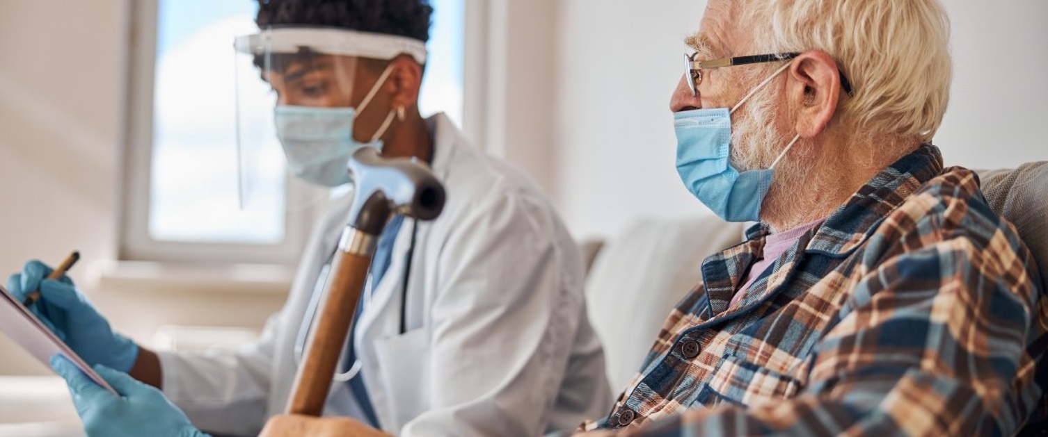 An elderly patient in a hospital accompanied by a volunteer