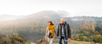 An older couple walking in the countryside