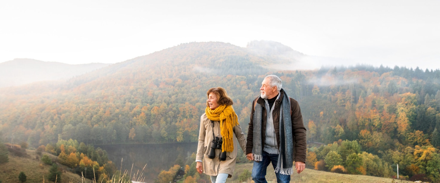 An older couple walking in the countryside