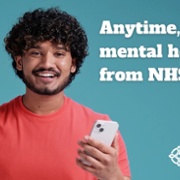 Male holding phone text reads Anytime, anywhere mental health support from NHS Wales