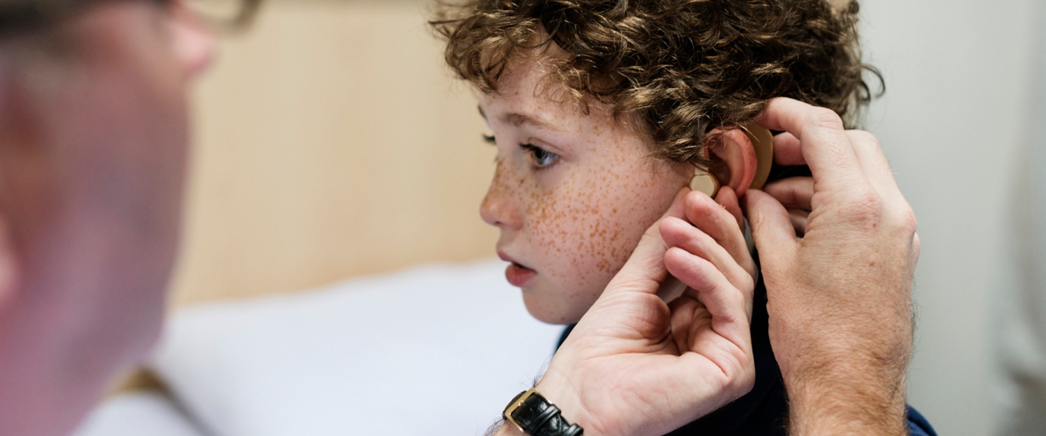 Young boy having his ears checked