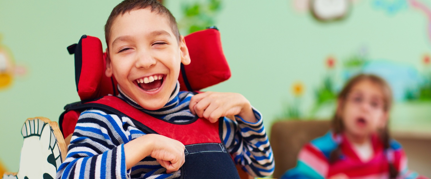 cheerful boy with disability at rehabilitation centre for kids with special needs