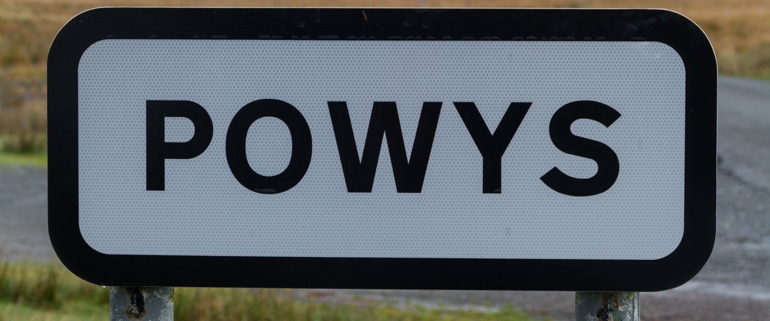 A sign that reads Powys