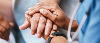 Doctor offering a caring hand to a patient