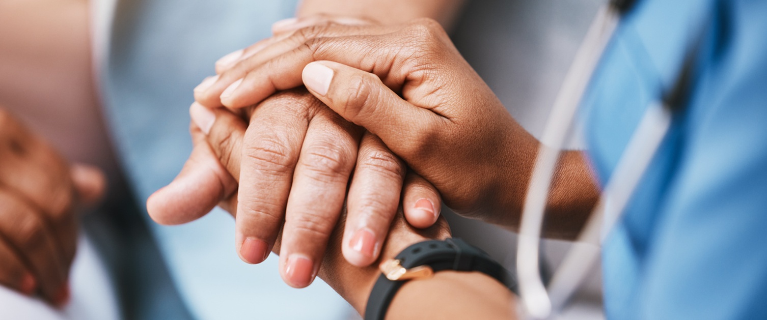 Doctor offering a caring hand to a patient