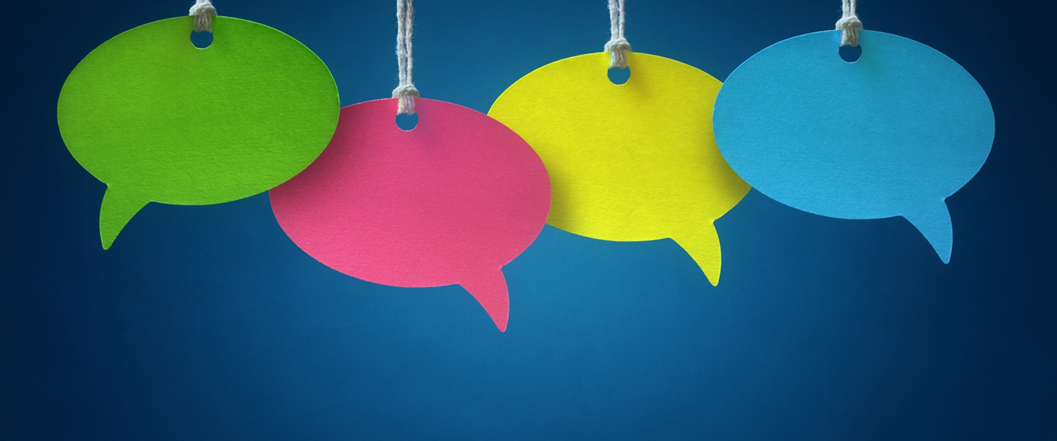 Blank colorful speech bubbles hanging from a cord over blue background