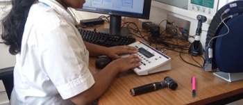 Female member of the audiology team operating the audiometer.