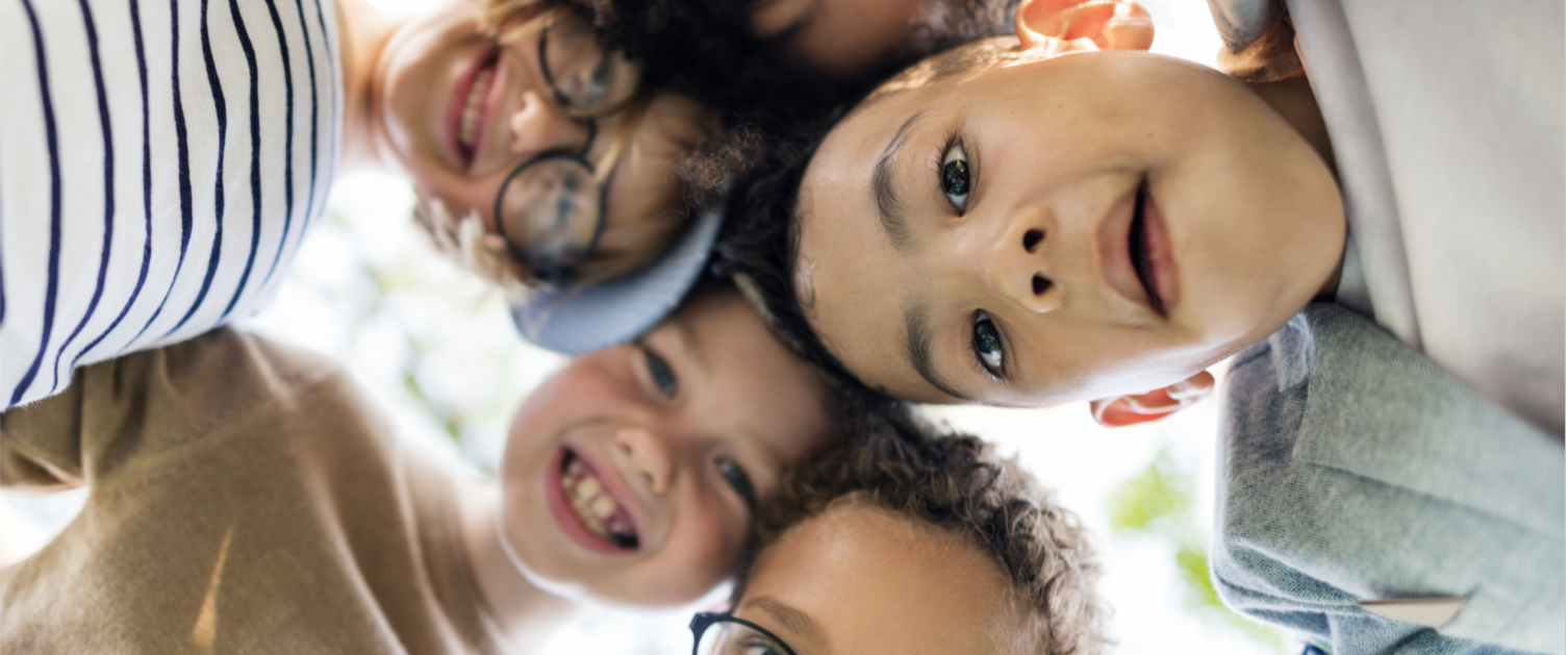 Kids huddled over camera