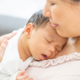 Newborn baby sleeping on mother