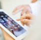 medical team analyzing MRI scan on tablet