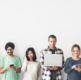 The image shows a group of individuals of various ages and ethnicities using different electronic devices