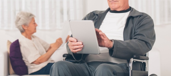 A patient using an iPad in a waiting are