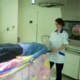 Danni in treatment room holding ribbon