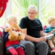 Grandparent with children in family room