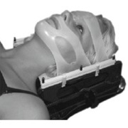 A person lying down with various fittings over their face.