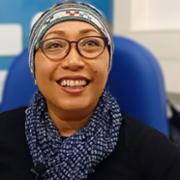 head and shoulders picture of Agustina Spooner smiling sitting in blue chair