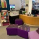 The inside of the library with the reception desk and seating.