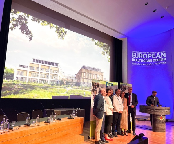 A group of people receive an award on stage.