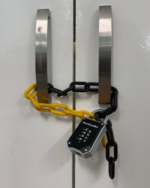 A door is locked with a padlock inside the escape room.