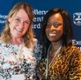 Two women receive an award at an event.