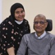 A daughter and father smile together.