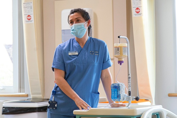 A nurse uses equipment on a ward.