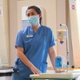 A nurse uses equipment on a ward.