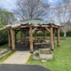 The wooden roundhouse structure in a garden at Velindre Cancer Centre.