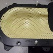 A plastic facemask with holes in it