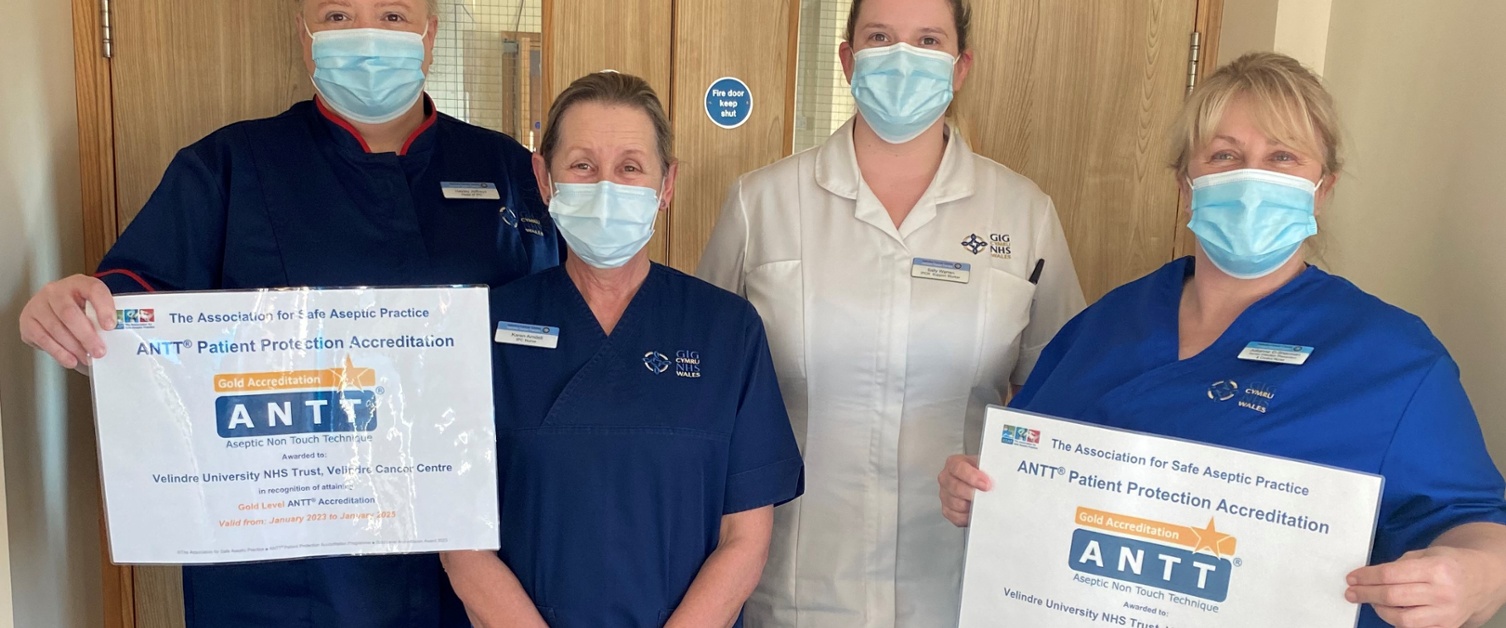 A group of staff hold certificates.